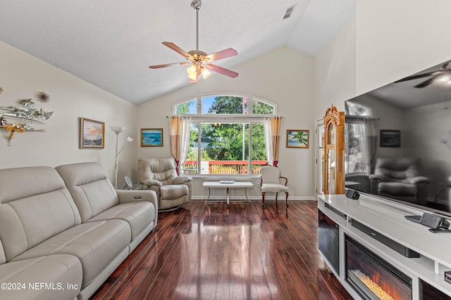 living room featuring vaulted ceiling, dark hardwood / wood-style floors, and ceiling fan