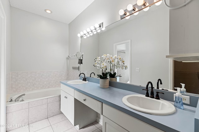 bathroom with vanity, tiled tub, and tile patterned floors