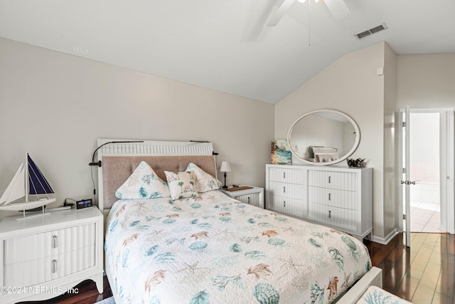 bedroom featuring dark hardwood / wood-style flooring, lofted ceiling, and ceiling fan