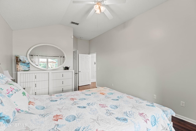 bedroom featuring dark wood-type flooring, ceiling fan, and vaulted ceiling