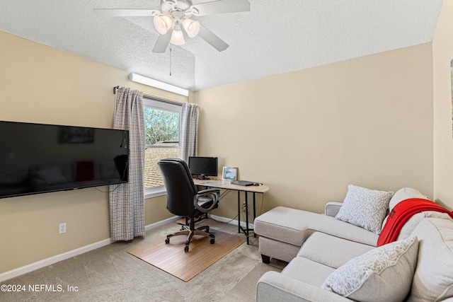 carpeted home office with a textured ceiling and ceiling fan