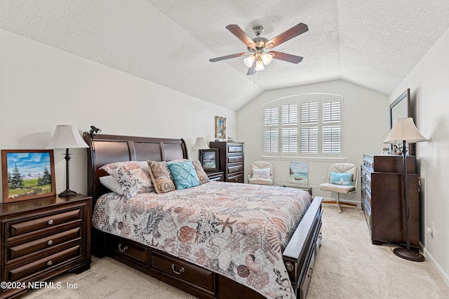 carpeted bedroom featuring lofted ceiling, a textured ceiling, and ceiling fan