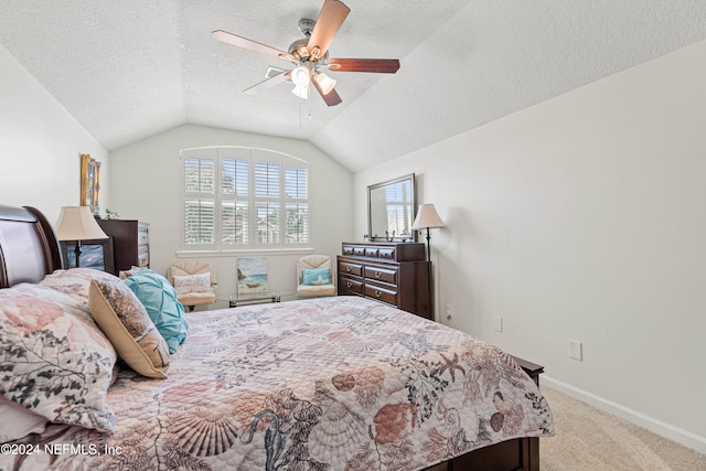 carpeted bedroom with vaulted ceiling, a textured ceiling, and ceiling fan