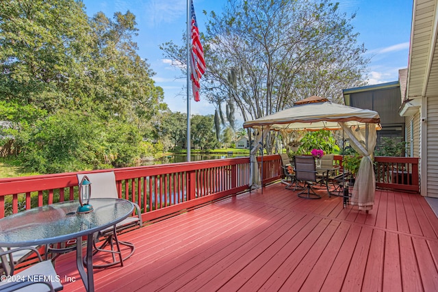 wooden terrace featuring a gazebo