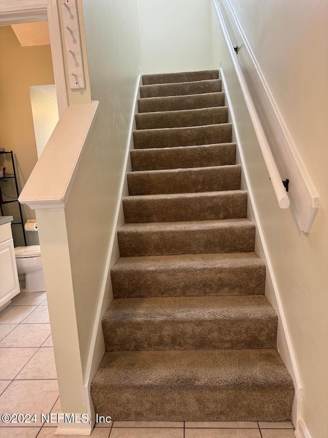 staircase with tile patterned floors