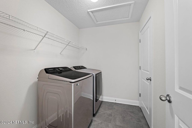 laundry area featuring washer and dryer and a textured ceiling