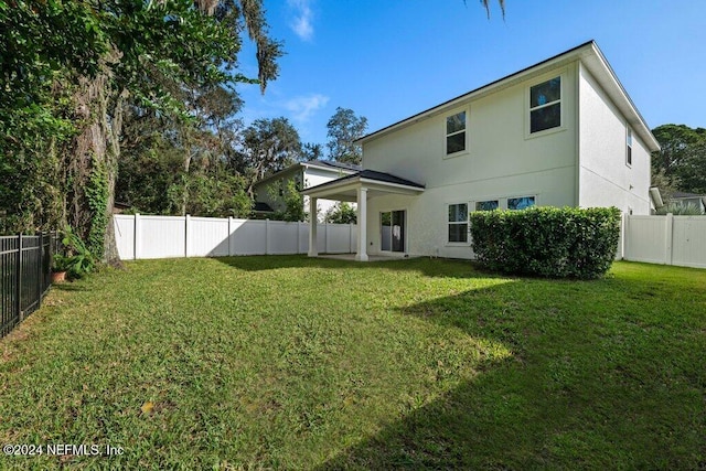 rear view of house with a lawn