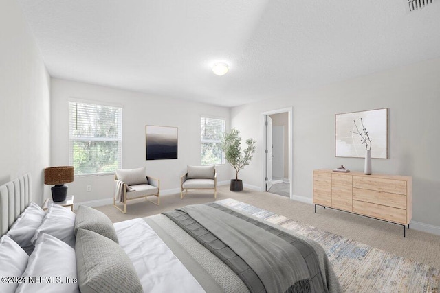 carpeted bedroom featuring multiple windows