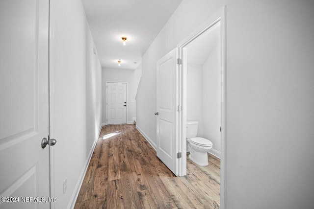 corridor with hardwood / wood-style floors