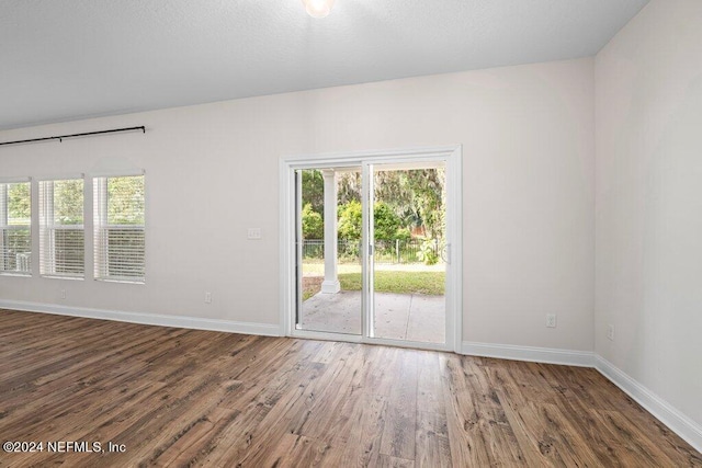 empty room with dark hardwood / wood-style flooring