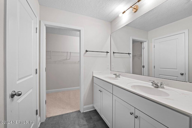 bathroom featuring vanity and a textured ceiling