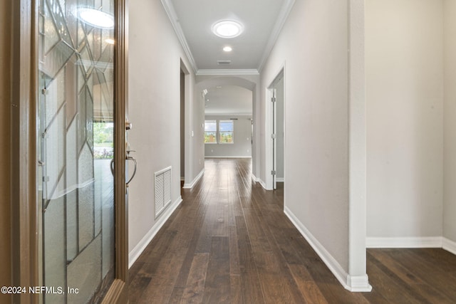 corridor featuring dark wood-type flooring and ornamental molding