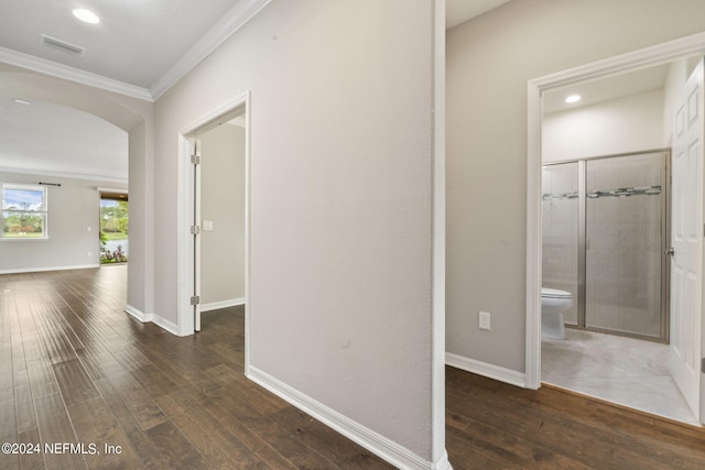 corridor with ornamental molding and dark hardwood / wood-style flooring