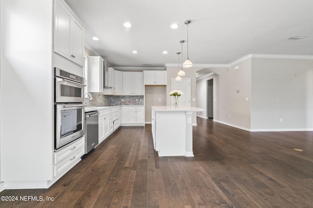 kitchen with a kitchen island, white cabinets, dark hardwood / wood-style floors, and stainless steel appliances