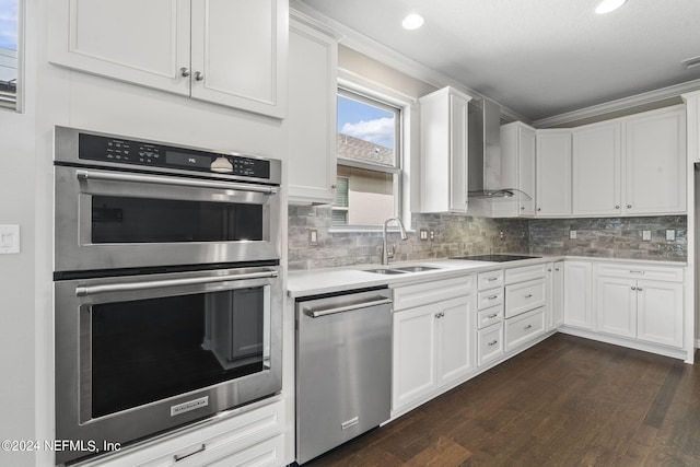 kitchen featuring sink, stainless steel appliances, wall chimney exhaust hood, white cabinets, and dark hardwood / wood-style floors