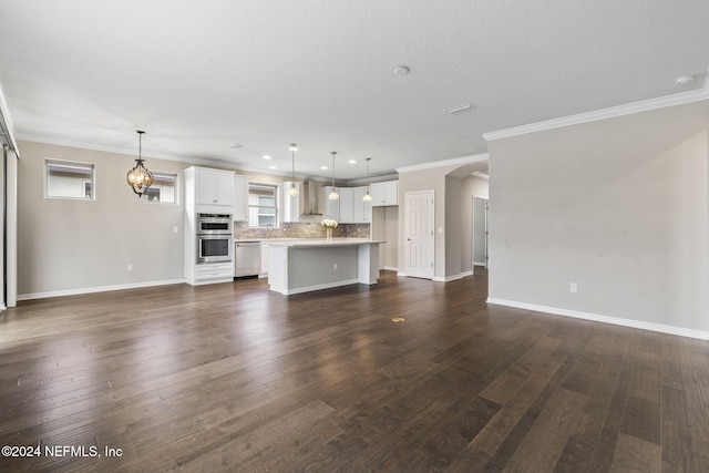 unfurnished living room featuring crown molding and dark hardwood / wood-style floors