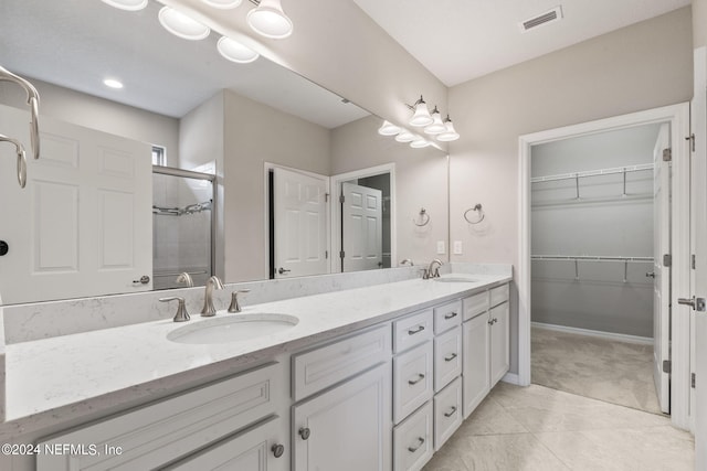 bathroom with vanity, tile patterned floors, and a shower with shower door