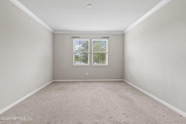 spare room with ornamental molding, a textured ceiling, and carpet flooring