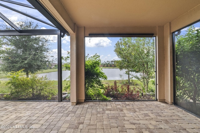 unfurnished sunroom with a water view