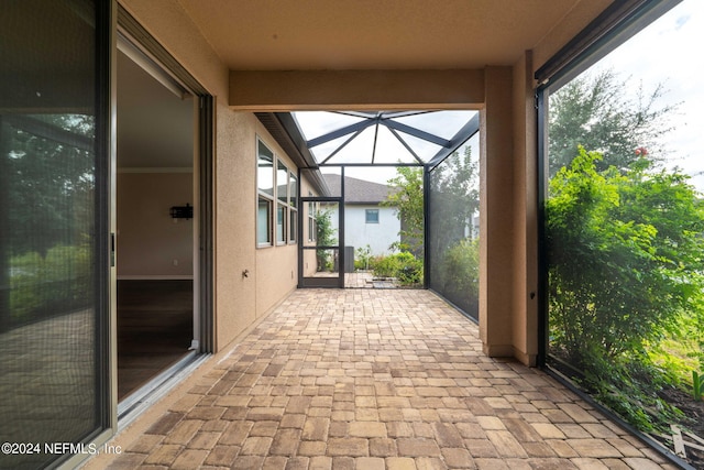 view of patio featuring a lanai