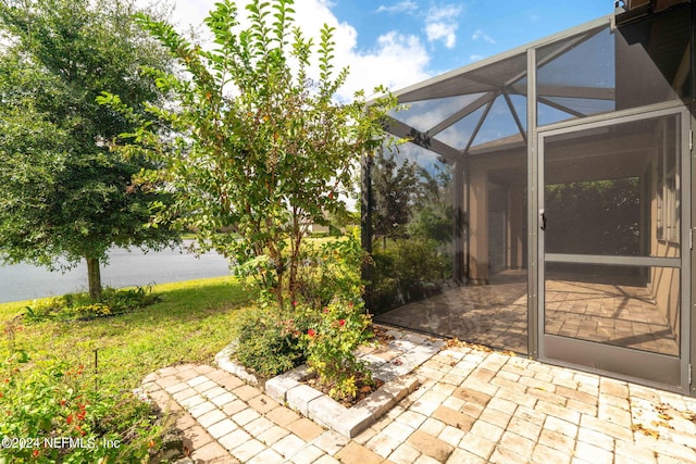 view of patio / terrace featuring a lanai