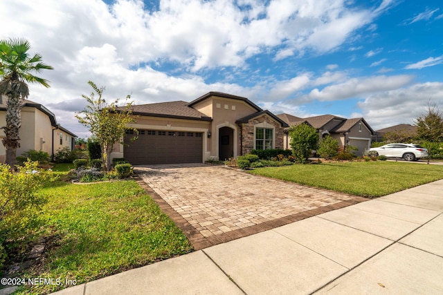 view of front of home with a garage and a front lawn