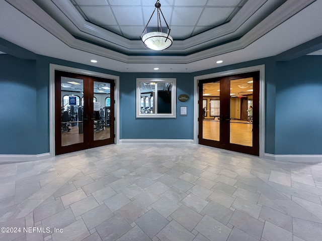 interior space featuring french doors and a tray ceiling