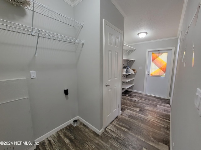 laundry room with electric dryer hookup, ornamental molding, and dark hardwood / wood-style flooring