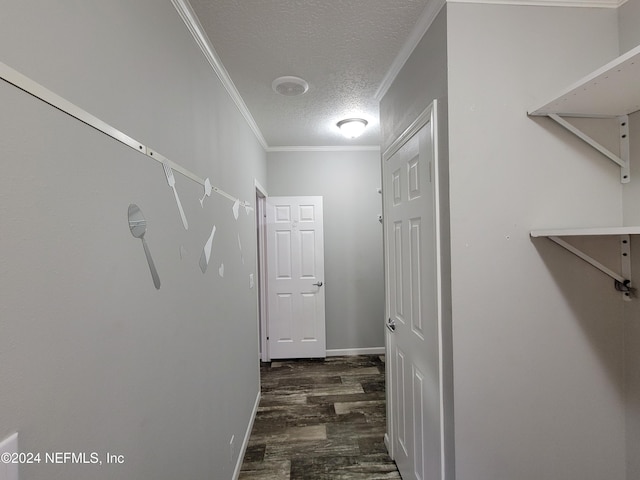 corridor featuring crown molding, a textured ceiling, and dark hardwood / wood-style floors