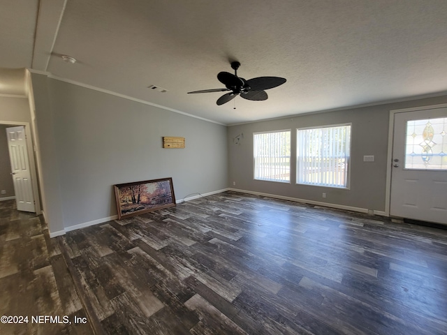 unfurnished living room featuring ornamental molding, a healthy amount of sunlight, and dark hardwood / wood-style flooring