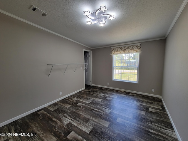 unfurnished room with ornamental molding, a textured ceiling, and dark hardwood / wood-style flooring