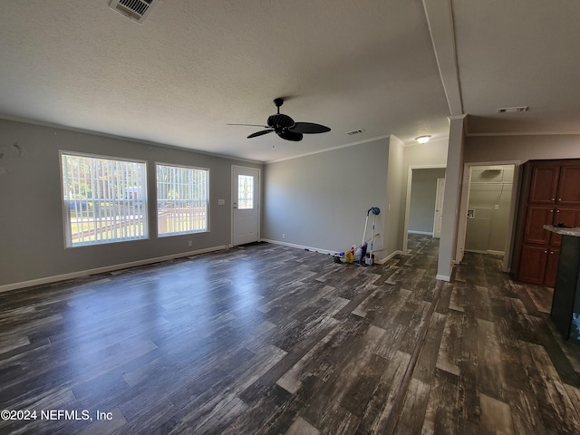 unfurnished living room with ornamental molding, dark hardwood / wood-style floors, a textured ceiling, and ceiling fan