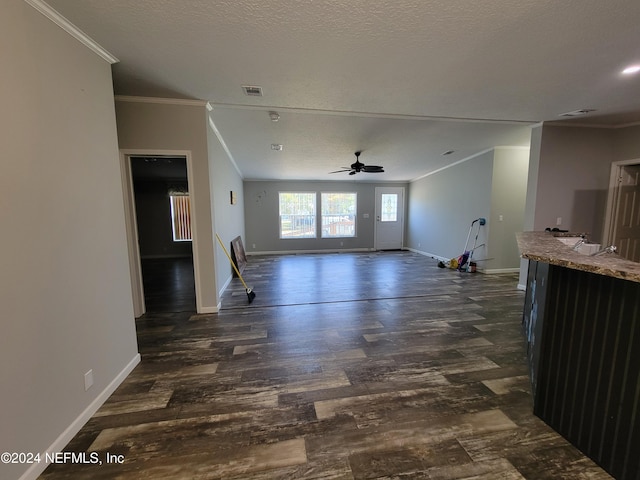 living room with ornamental molding, a textured ceiling, dark hardwood / wood-style floors, and ceiling fan