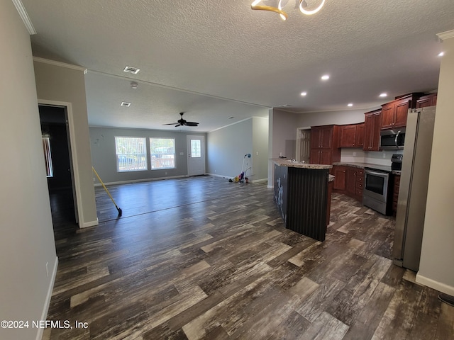 kitchen with a kitchen island, ceiling fan, stainless steel appliances, ornamental molding, and dark hardwood / wood-style floors