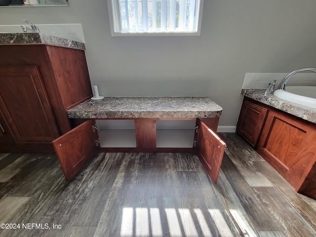 bathroom with a tub, hardwood / wood-style flooring, and sink