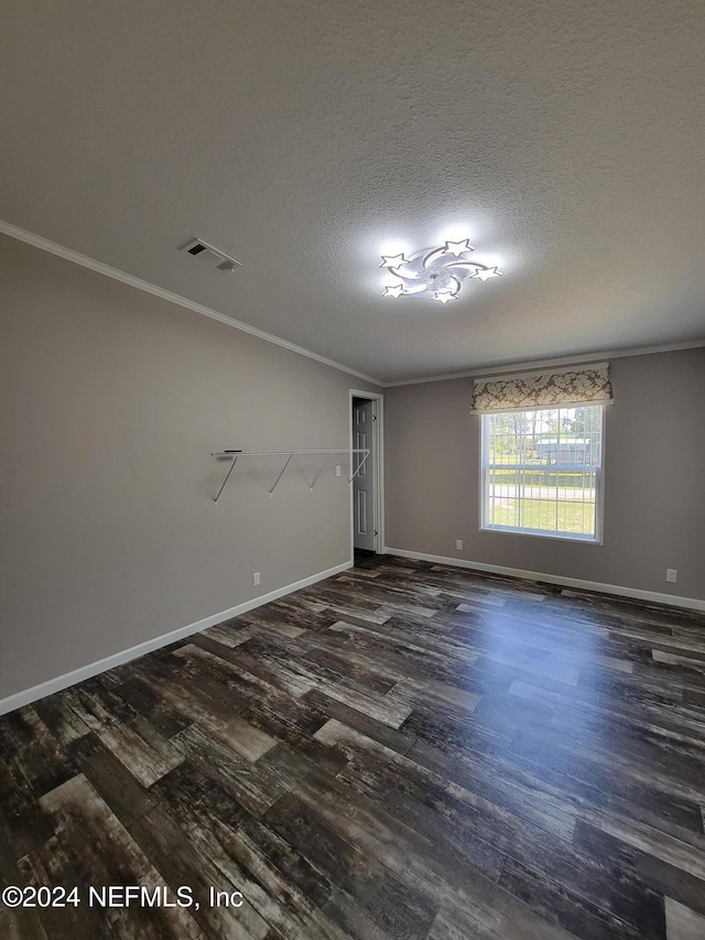 unfurnished room with a textured ceiling, dark hardwood / wood-style flooring, and ornamental molding