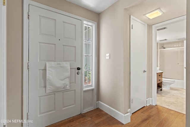 foyer entrance with hardwood / wood-style flooring