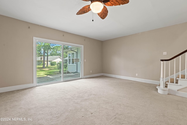 unfurnished living room featuring carpet floors and ceiling fan