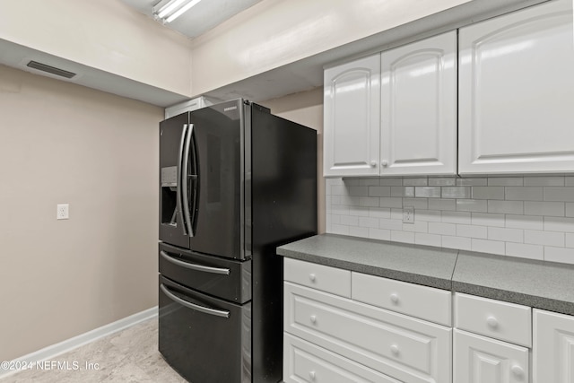 kitchen featuring decorative backsplash, white cabinetry, and stainless steel fridge with ice dispenser