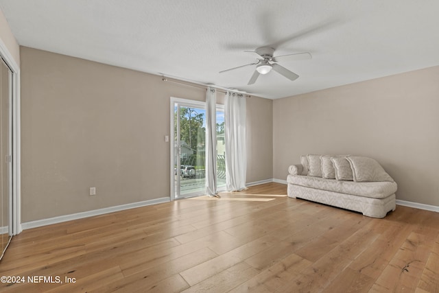 sitting room with ceiling fan, a textured ceiling, and light hardwood / wood-style flooring