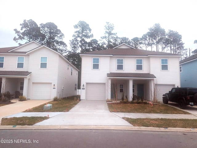 traditional-style home featuring an attached garage and concrete driveway