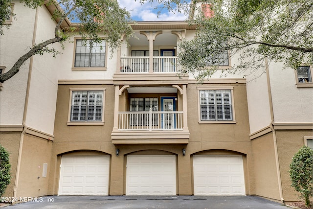 multi unit property with a balcony and a garage