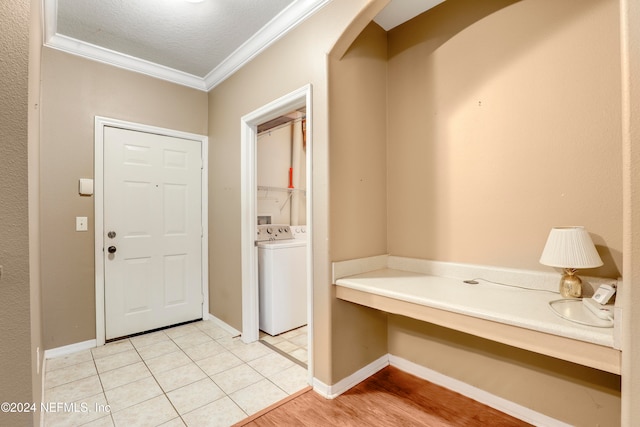 entrance foyer with light hardwood / wood-style flooring, crown molding, and a textured ceiling