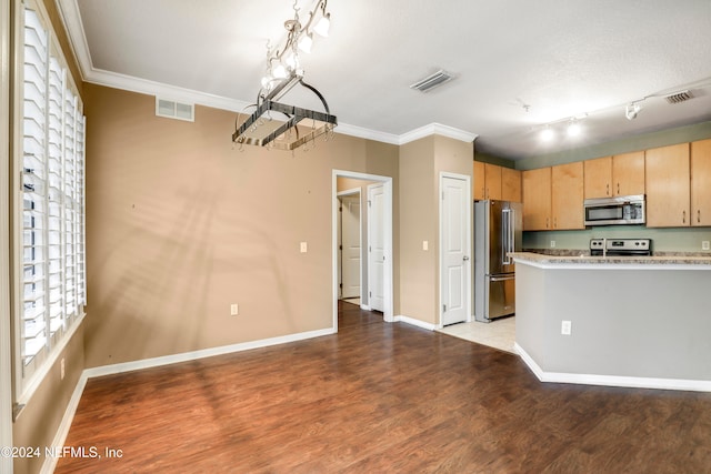 kitchen with light wood-type flooring, stainless steel appliances, ornamental molding, and light brown cabinets