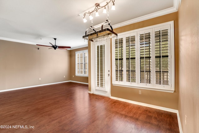 spare room with crown molding, wood-type flooring, and ceiling fan