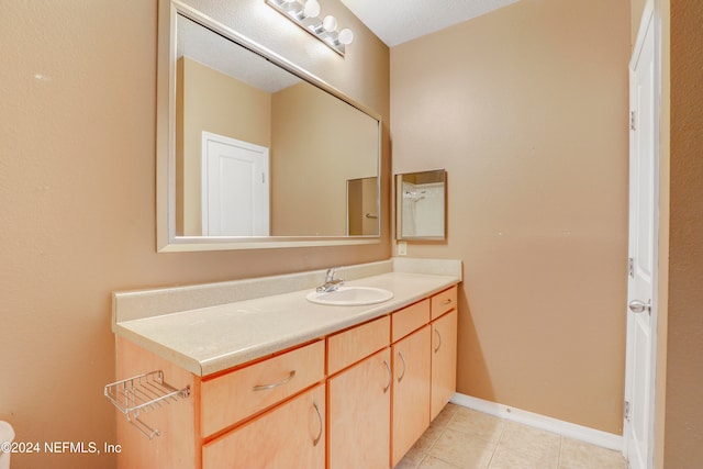 bathroom with vanity and tile patterned floors