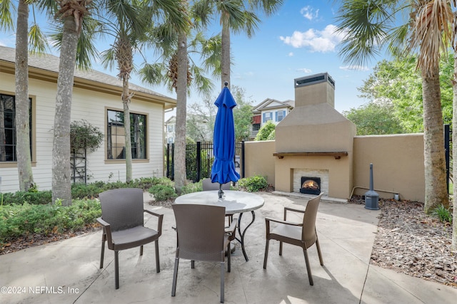 view of patio / terrace with an outdoor fireplace