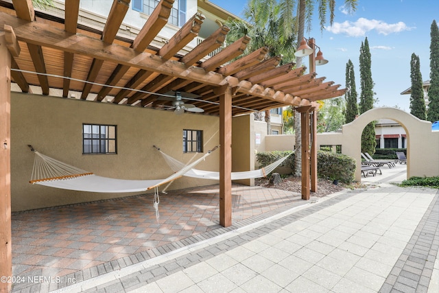 view of patio / terrace with ceiling fan and a pergola