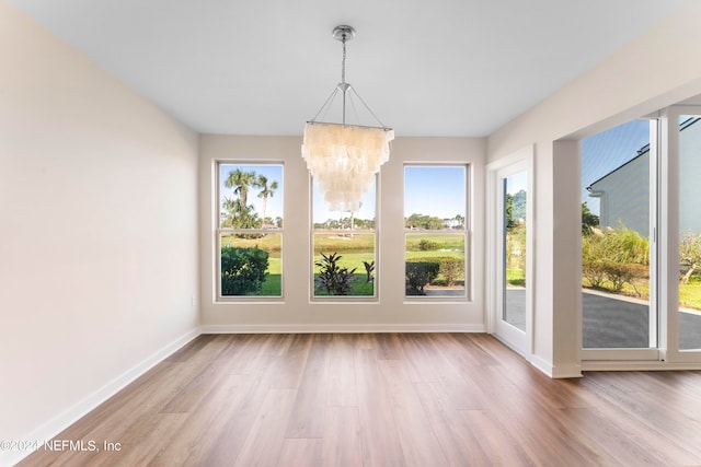 unfurnished sunroom featuring an inviting chandelier