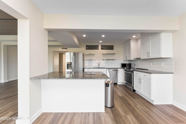 kitchen featuring white cabinetry, hardwood / wood-style flooring, and stainless steel appliances